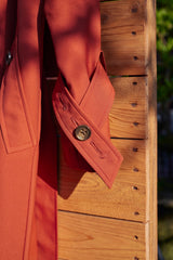 Trench coat with double collar in brick red