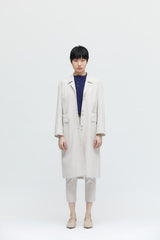 Beige long coat with multiple cut-outs